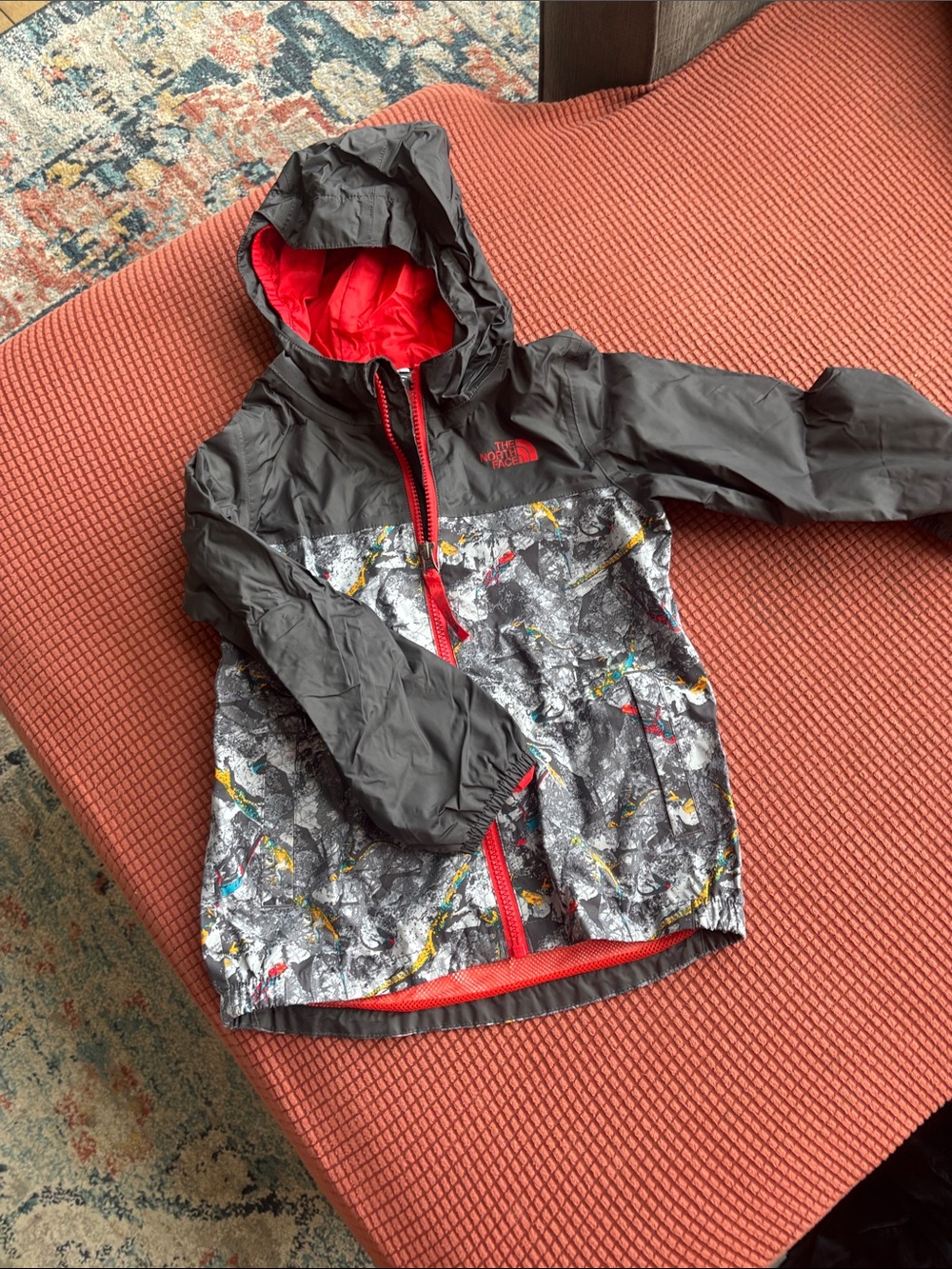 The North Face Kids' Gray Rain Jacket with Red Lining and Multi-Print Panels